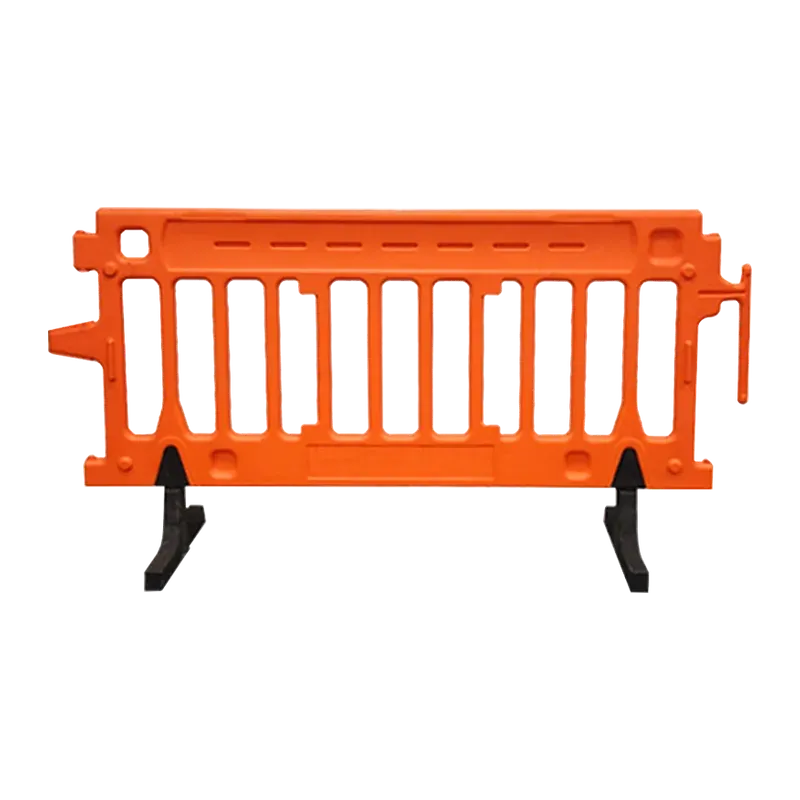 Orange plastic crowd barricade with moulded vertical bars and black feet.