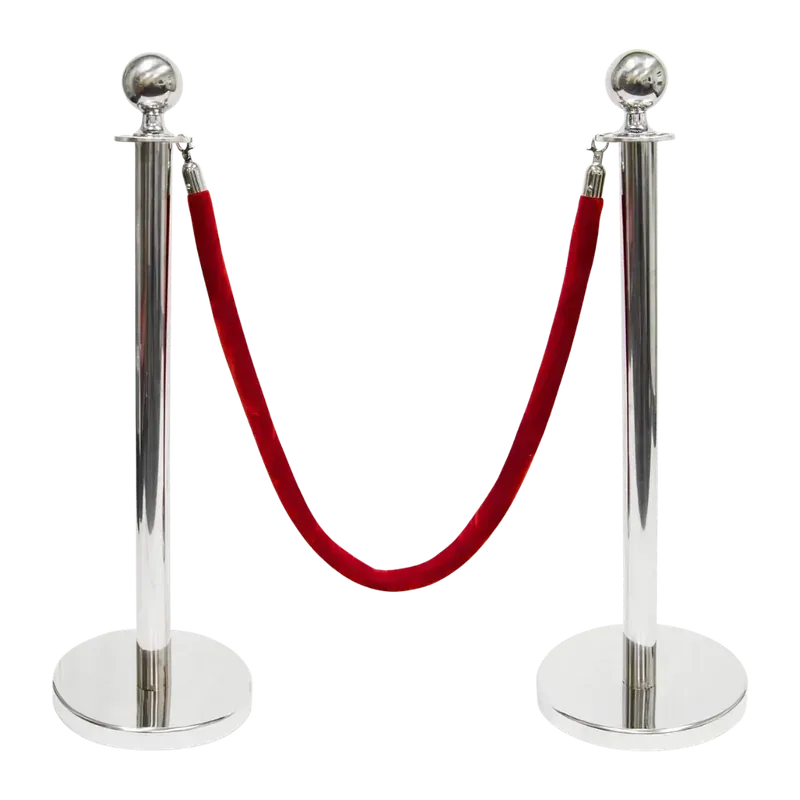 Two polished chrome rope posts with ball tops, a deep red velvet rope hung between them on chrome end fittings.