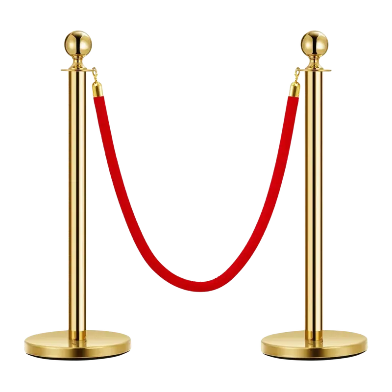 Two brass finished rope posts with ball tops, a red velvet rope hung between them on gold end fittings.