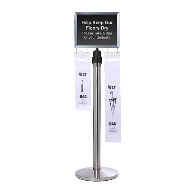 Chrome post with a sign reading Help Keep Our Floors Dry and wet umbrella bags hanging beneath it.